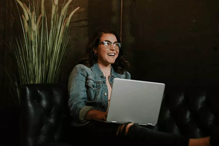 women smiling with computer